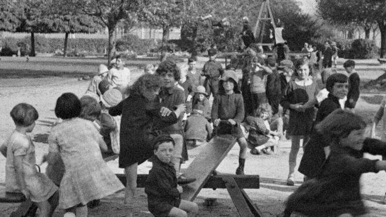 A group of schoolchildren playing in an Adelaide park in 1925