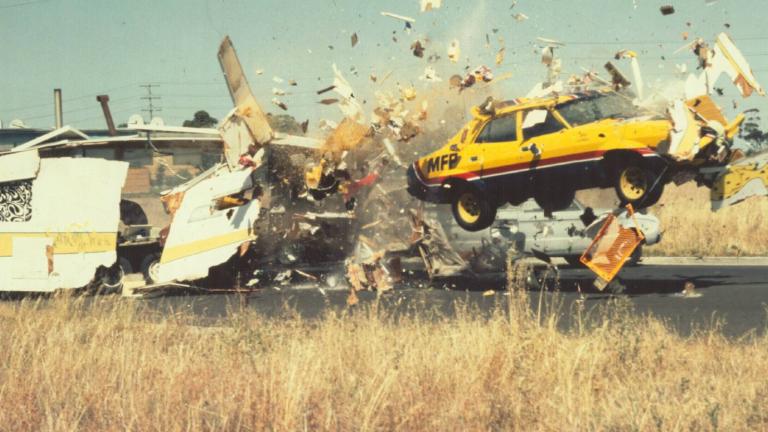 A car smashes through a caravan in a stunt from Mad Max
