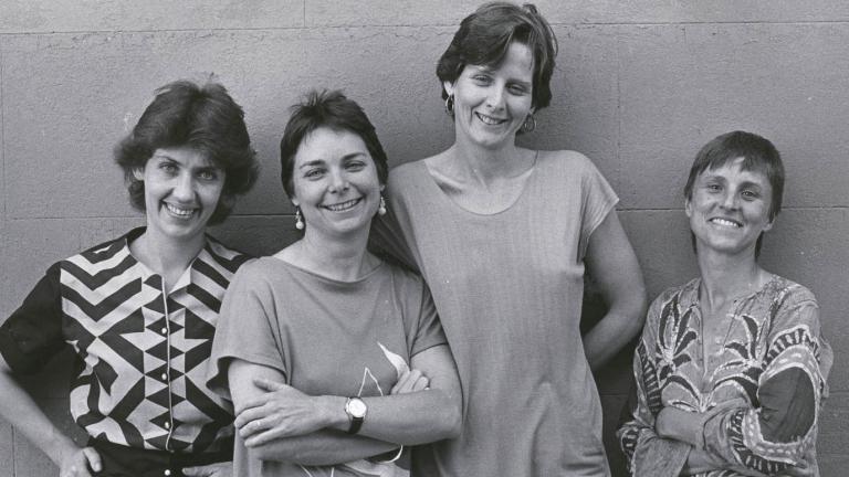 Filmmakers Margot Nash, Megan Mcmurchy, Jeni Thornley and Margot Oliver standing in front of a wall smiling for the camera.