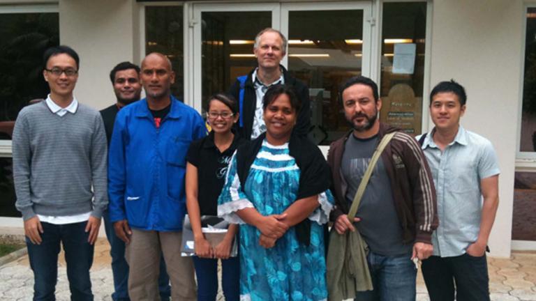 A group of conference delegates standing outside the New Caledonia national archives.