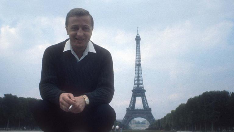 Graham Kennedy poses for the camera in Paris with the Eiffel Tower in the background