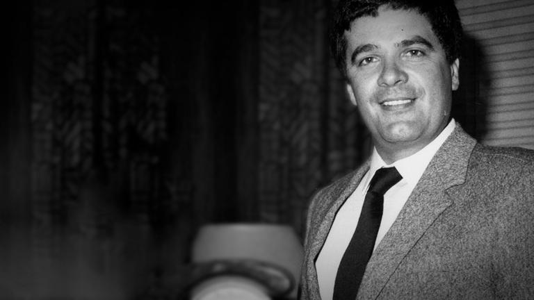 Head and shoulders shot of Simon Townsend wearing a suit and tie and smiling directly at camera.