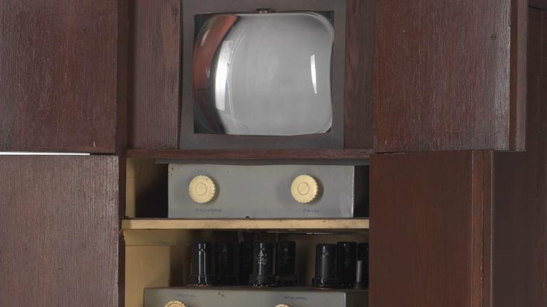 Close up of Sid Oldroyd's homemade TV showing screen and dials inside a wooden cabinet, built in 1956.