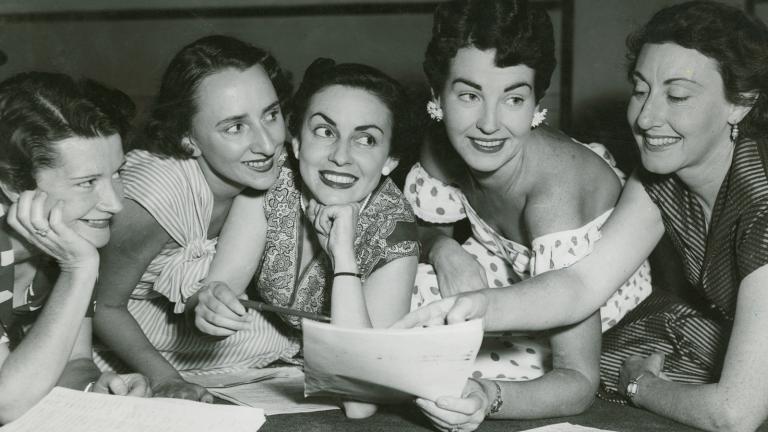 A group of 5 women reading a radio script, circa 1950s.
