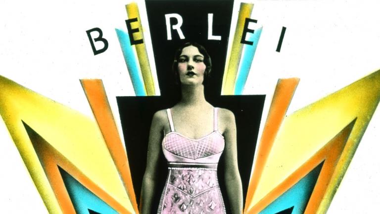 A woman wearing a pink foundation garment stands amidst art deco design elements suggesting power and lightening.