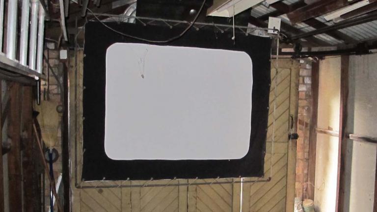 A screen hanging in a garage in Wollongong, part of the 1940s home cinema set-up of film projectionist Eddie Vormister