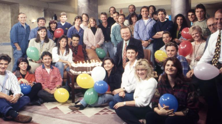 Bert Newton surrounded by his TV crew
