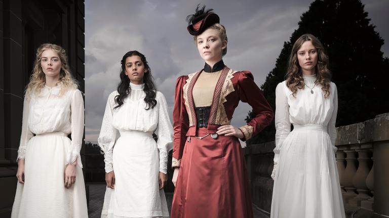 Four womern standing in a line in period costume