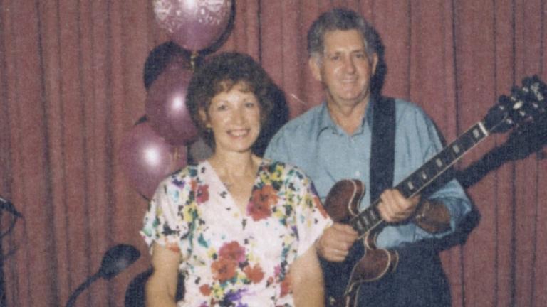 Album cover for Christmas Wishes from Lindsay and Joan. Features Joan and Lindsay posing for the camera; he is holidng a guitar.