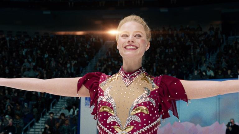 Figure skater smiling with her arms extended Figure skater smiling with her arms extended