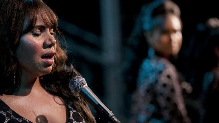 Deborah Mailman singing on stage in a still from the film The Sapphires