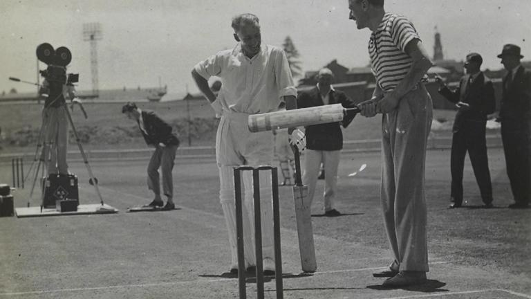 Donald Bradman and director Miles Mander in discussion on a cricket pitch Donald Bradman and director Miles Mander in discussion on a cricket pitch