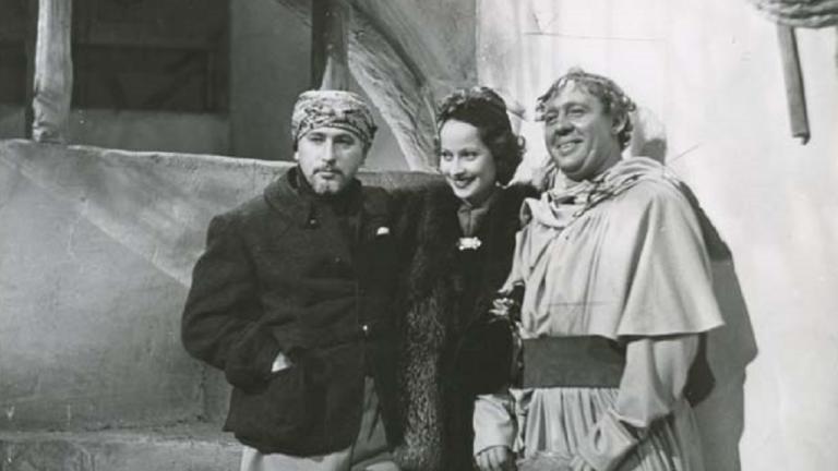 Merle Oberon on the set of 'I Claudius' Merle Oberon stands between two men on the set of "I Claudius'.