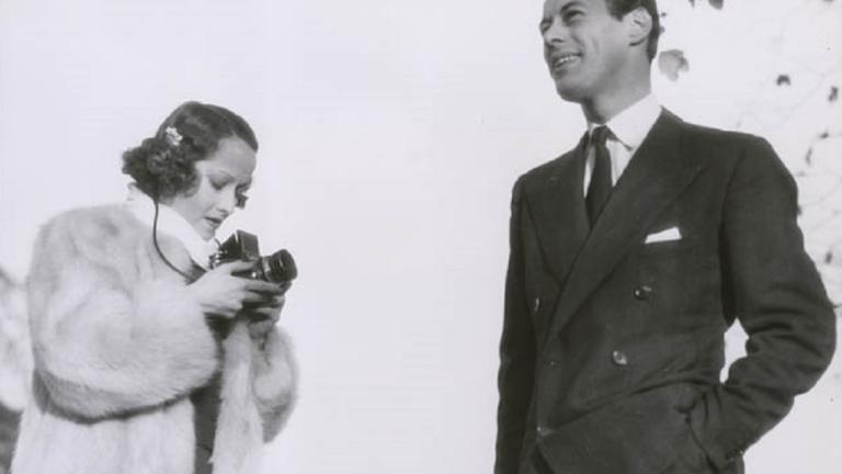 Merle Oberon with Rex Harrison Merle Oberon in a fur coat standing next to Rex Harrison in a smart suit