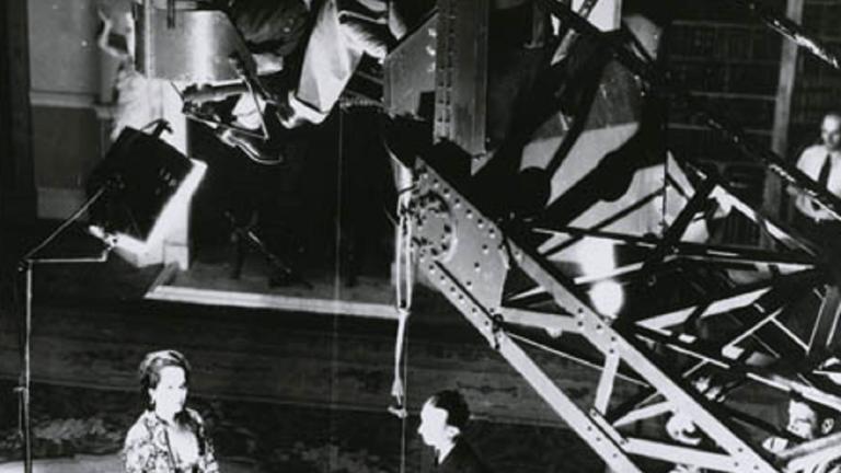 'The Scarlet Pimpernell' production shot with Merle Oberon Overhead production shot of Merle Oberon acting with a movie camera on a crane above her