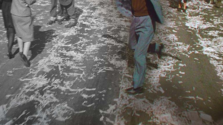 A partly colourised image of a man dancing with raised hat in Sydney, part of a crowd celebrating the end of the Second World War A partly colourised image of a man dancing with raised hat in Sydney, part of a crowd celebrating the end of the Second World War