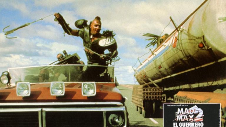 Mad Max 2 lobby card showing Wez (Vernon Wells) swinging a grappling hook