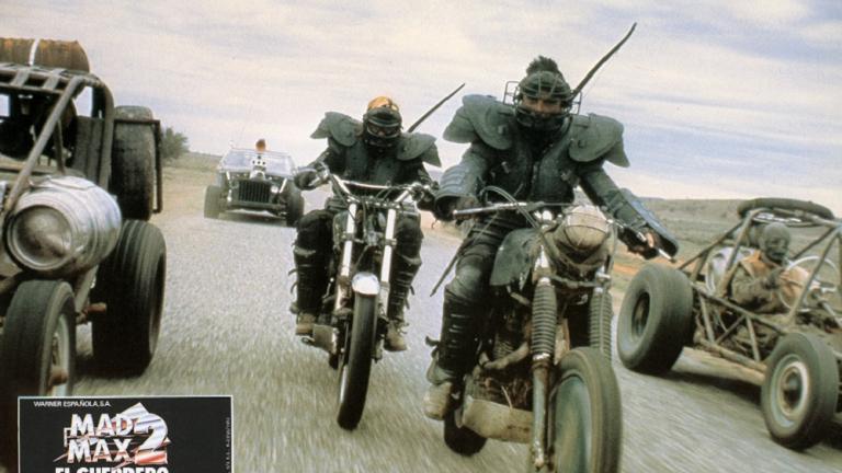 Mad Max 2 lobby card featuring heavily costumed stunt men on motorbikes.