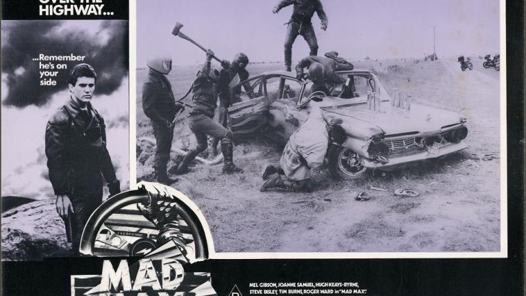 Lobby card for Max Max shows a gang attacking a car. Lobby card for Max Max shows a gang attacking a car.