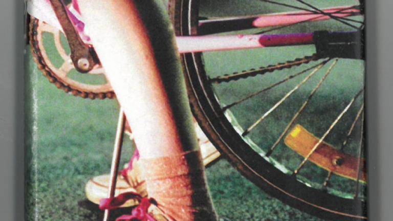 Cassette cover featuring a close up of a woman's leg and foot on a bicycle. Text reads: Crush. Soundtrack by Karli White. Cassette cover featuring a close up of a woman's leg and foot on a bicycle. Text reads: Crush. Soundtrack by Karli White.