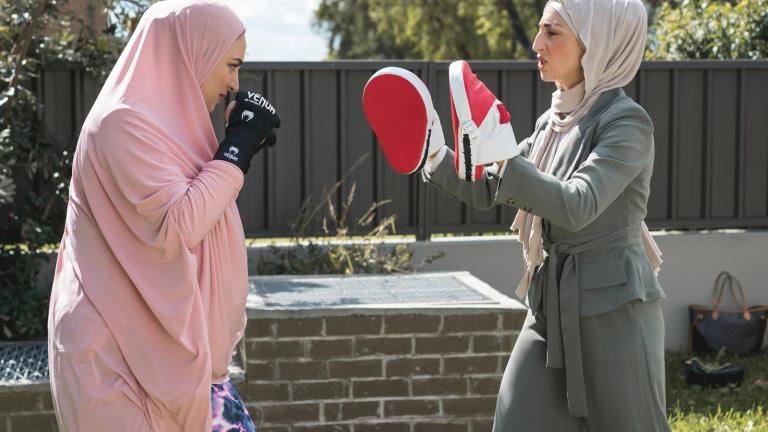 Scene from Halal Gurls Two women are facing each other in a backyard doing a boxing workout.