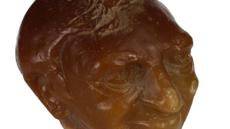 Sculpted orange wax candle of Graham Kennedy's head. Sculpted orange wax candle of Graham Kennedy's head.