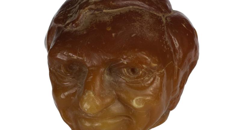Sculpted orange wax candle of Graham Kennedy's head. Sculpted orange wax candle of Graham Kennedy's head.