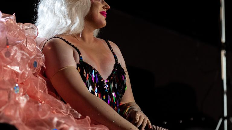 Drag queen Toni Kola seated in costume during a break in filming