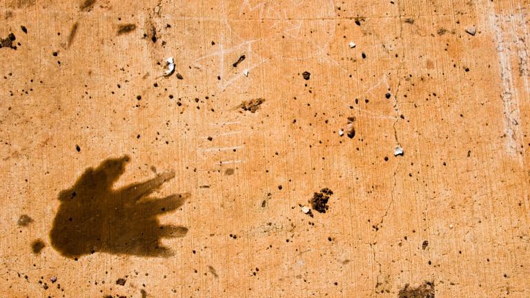 A hand print on rocky desert sand