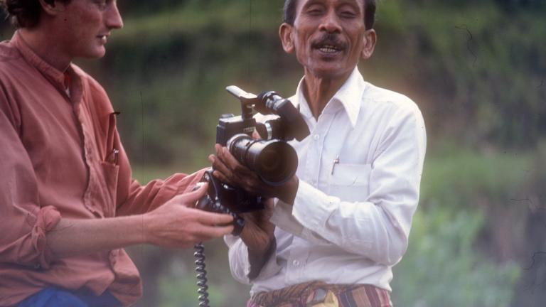 John Darling with I Gusti Made Sumung ohn Darling with I Gusti Made Sumung, holding a video camera.