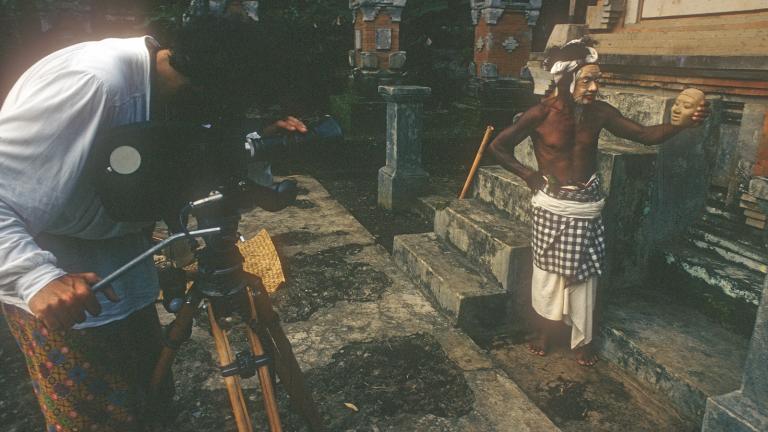 Lorne Blair filming John Darling's 'Lempad of Bali' A camera man filming a balinese man in cultural dress and mask
