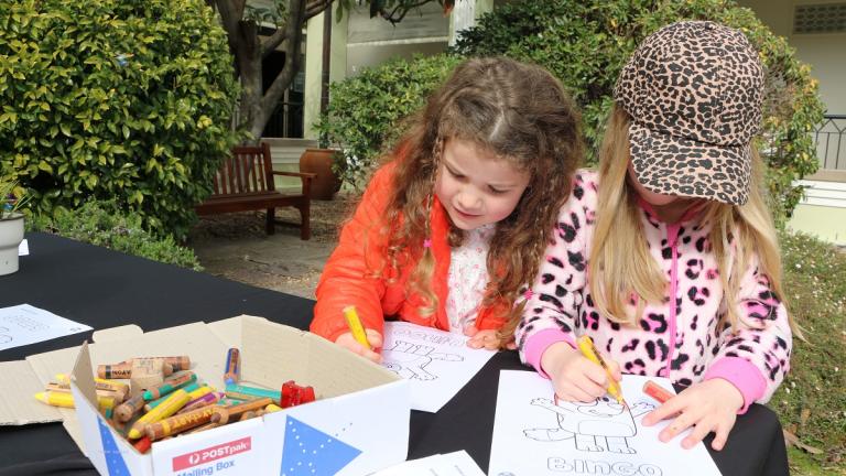 Fun Bluey-themed activities for kids at the NFSA Two girls colouring a drawing of Bluey
