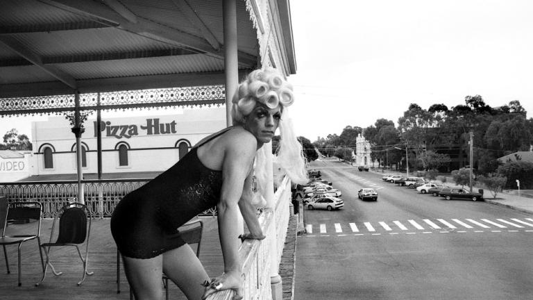 Hugo Weaving in costume leaning on the Palace Hotel balcony in Broken Hill.