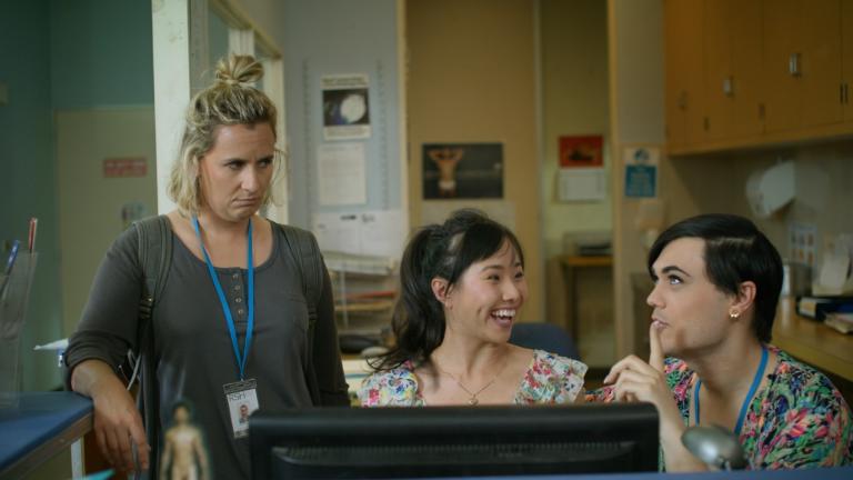 Two women and a man in the office of a clinic