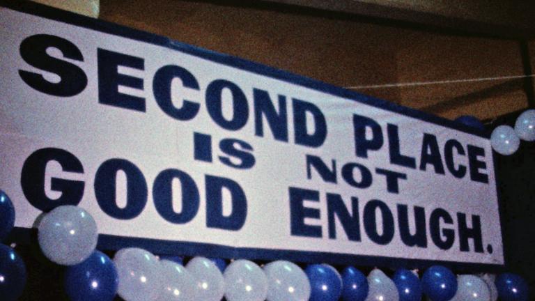 Carlton FC banner at the 1970 AFL Grand Final. Banner for the Carlton Football Club at the 1970 AFL Grand Final that reads 'Second Place is Not Good Enough'. The banner is surrounded by blue and white balloons.