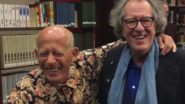 Pianist David Helfgott has his arm around actor Geoffrey Rush's neck and is giving a thumbs up sign and laughing