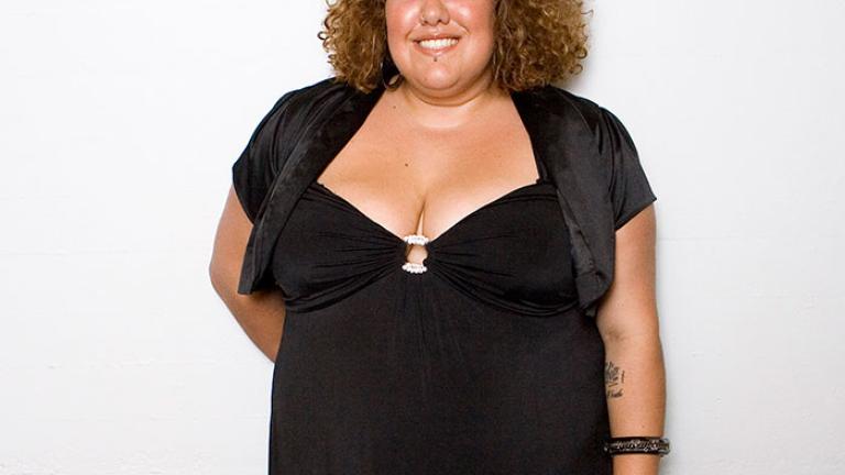 Casey Donovan smiling to camera in black dress