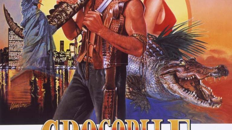 Australian Crocodile Dundee poster Australian poster for Crocodile Dundee showing illustrations of Mick Dundee, Sue Charlton and a crocodile with the outback and the New York City skyline as backgrounds
