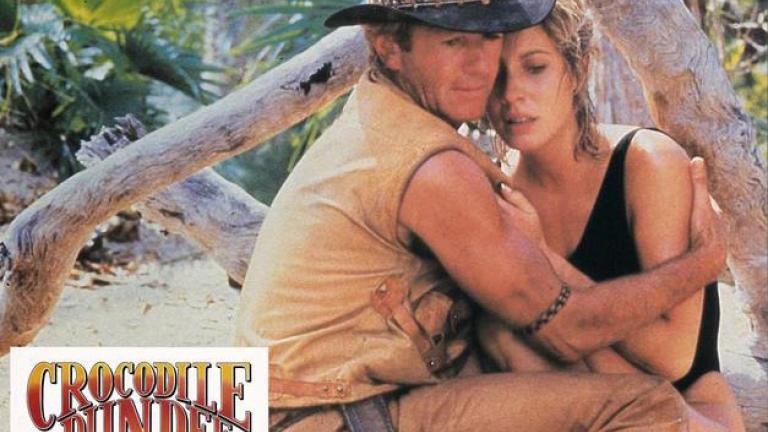 Crocodile Dundee German lobby card 5 Lobby card depicting Mick Dundee in a protective embrace with Sue Charlton after she got attacked by a crocodile