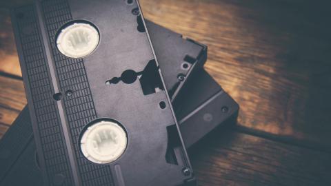 Stack of video tapes on a wooden table