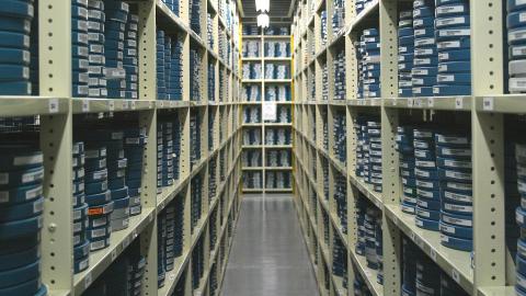 Shelves filled with stacks of film canisters in a vault at the NFSA
