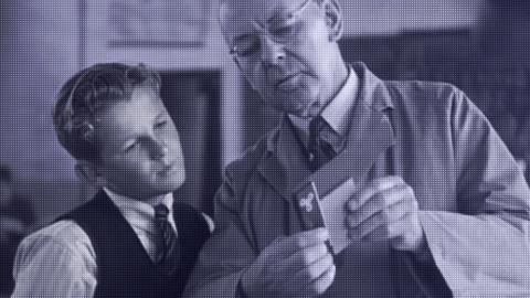 A teenaged boy and teacher looking at a piece of paper