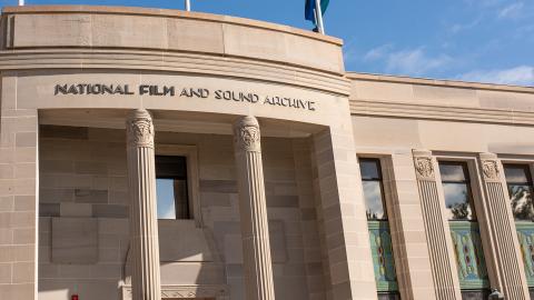 Front facade of an art deco style building with columns at the front and a sign saying National Film and Sound Archive.