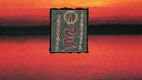 An Aboriginal drawing of a snake surrounded by symbols and a striped and dotted pattern against a red and black sunset