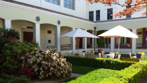 Tables and umbrellas set up in the NFSA courtyard in the sunlight