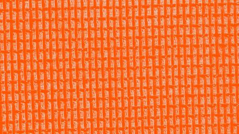 A stylised detail of a hi-fi speaker in close-up and tinted orange
