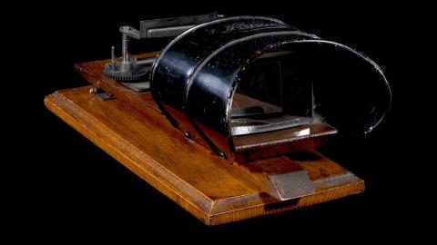 A kinora flipper viewer on a wooden platform