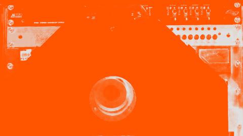 A close-up image of audio equipment that has been tinted orange