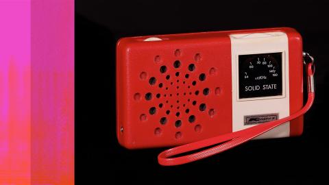 A red kmart branded portable radio with a wrist strap.