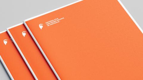 Documents featuring a white National Film and Sound Archive kookaburra logo on an orange cover